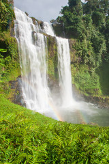 Tad Yuang waterfall with bright rainbow.