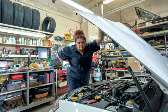 Female Mechanic Working on Cars in Her Shop