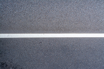 Fototapeta premium Asphalt road with a dividing strip and a place for the inscription