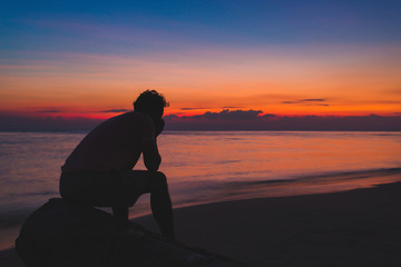 man alone Lonely by the ocean. At the time the sun