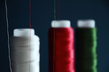 threads in blue colors on the background of a sewing machine