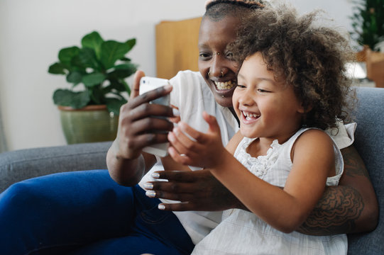 Mother and daughter using phone