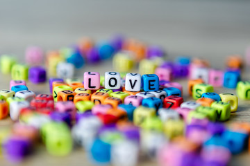 Beautiful beads colorful placed on the table as Love