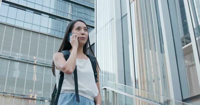 Woman talk to cellphone in city