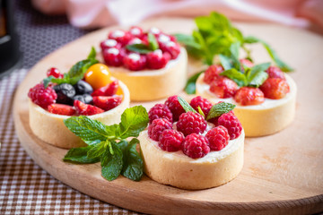 raspberry cake with cream cheese, mint on crumbly dough. Cake with raspberries