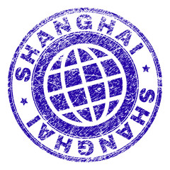 SHANGHAI stamp print with grunge texture. Blue vector rubber seal print of SHANGHAI tag with dirty texture. Seal has words placed by circle and planet symbol.