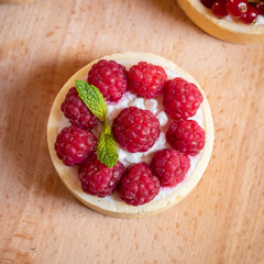 raspberry cake with cream cheese, mint on crumbly dough. Cake with raspberries
