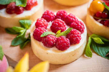 raspberry cake with cream cheese, mint on crumbly dough. Cake with raspberries