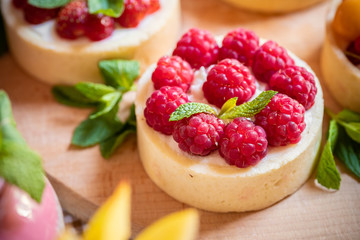 raspberry cake with cream cheese, mint on crumbly dough. Cake with raspberries
