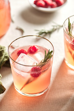 Freshly made mocktail with raspberry, rosemary and ice.