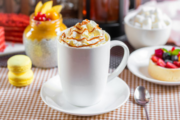 cup of coffee with whipped cream and dipping