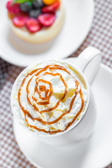 cup of coffee with whipped cream and dipping