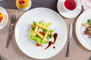 Salad with corn, arugula, algae, tomatoes and greens