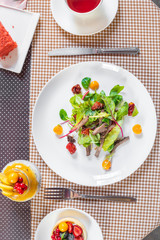 Salad with meat, arugula, algae, tomatoes and greens