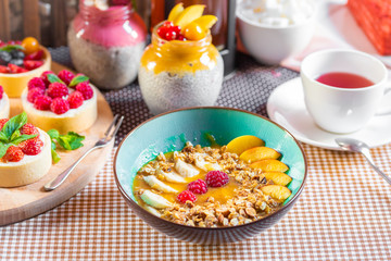 Porridge of muesli with fruit. Fresh fruit in porridge. Muesli with fruits. Muesli with fruit puree.