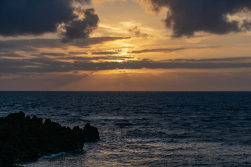 Sunrise over the Atlantic Ocean from Fuencaliente, La Palma with volcanic igneous rocks in the foreground