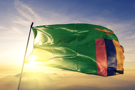 Zambia zambian flag textile cloth fabric waving on the top sunrise mist fog
