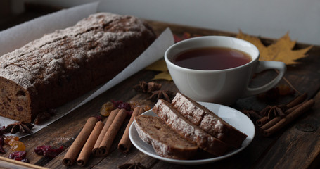 Homemade banana bread with anis star and cinnamon on a dark wooden background