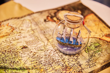 old ship with sails in a closed bank is on the old map