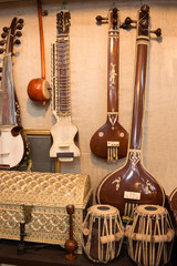 Indian musical instruments stringed guitars called sitars and Indian Folk percussion barrel shaped...