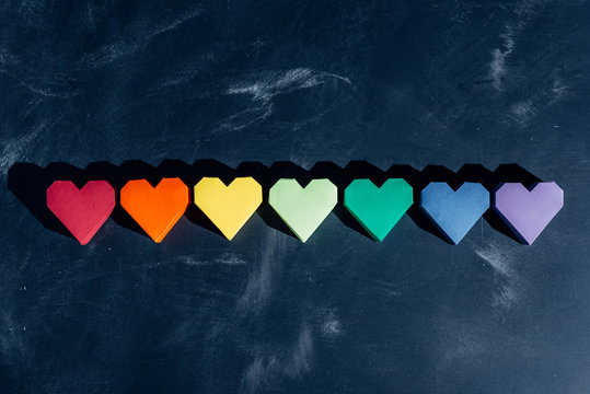 Rainbow paper hearts in a row