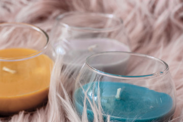 set detail of decoration with three candles of yellow gray and blue colors on pink background