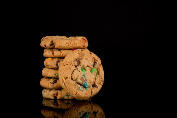 chocolate chip cookies on black background, reflective surface, stacked cookies, Copy space