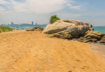 Fototapeta na wymiar The rocky and public Coral Beach with view to Pattaya
