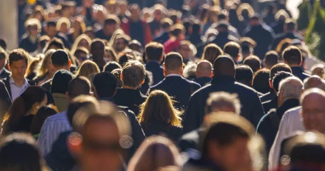 Fotobehang Crowd of people walking busy city street backlit © blvdone