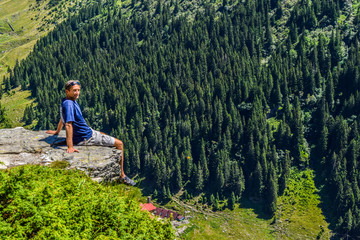 Tourist on the cliff edge Transfegerashskoy mountain road.