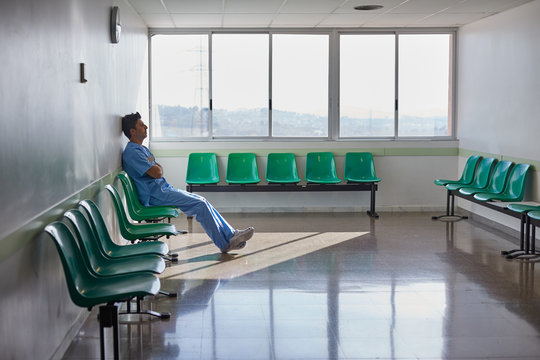 Doctor resting alone in a hospital waiting room.