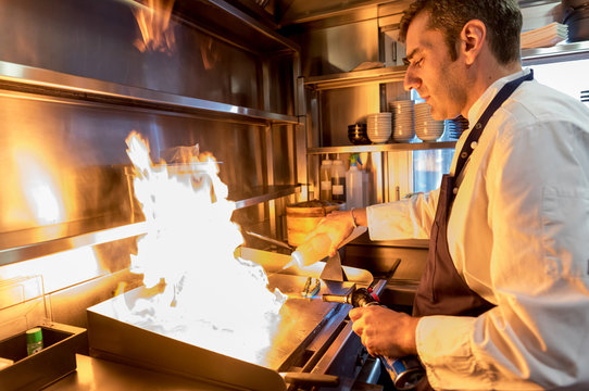 Man cooking in bright flame