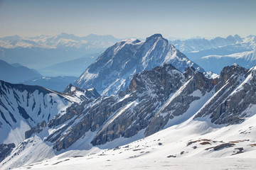 Snowy rock walls of Wettersteingebirge and Hohe Munde peak of Mieminger Kette range in Northern Limestone Alps in German Austrian border, in background Zillertaler and Stubaier Alpen ranges in Tirol