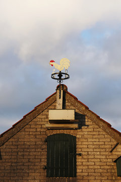 Close-up of a weather vane on top of a shed's roof