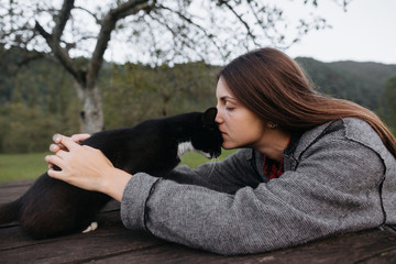Young female and black cat
