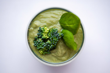 healthy vegetarian smoothie in glass with green smoothie, broccoli and spinach