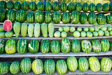 many ripe watermelons on the roadside market