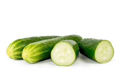 Whole cucumbers and half a cucumber. Isolated.