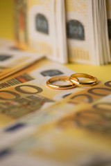 Golden wedding rings on a Euro bill. Divorce or infidelity concept