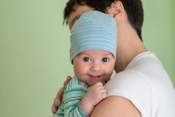 Baby with a cap enjoying on mothers shoulder © nedomacki