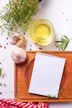 Empty notebook for recipes with fresh herbs and spices