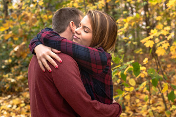 A beautiful girl hugs her boyfriend. Couple in love.