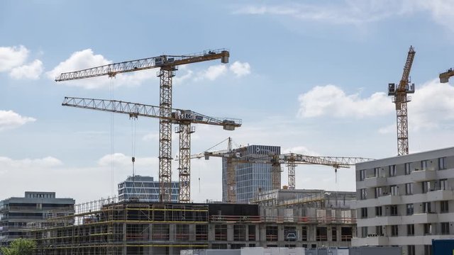 Operating cranes at building construction site