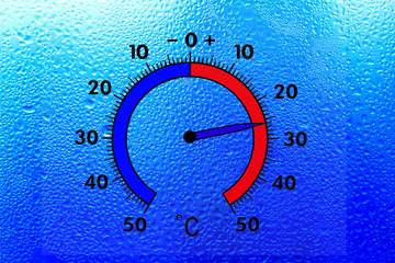 The thermometer on the wet window shows plus 26 degrees celsius