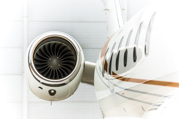 High detailed closeup view on small white private business jet windows engine