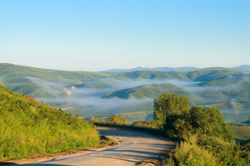 The mountain road from Serebryansk to Ust-Kamenogorsk in the early morning East Kazakhstan region,...