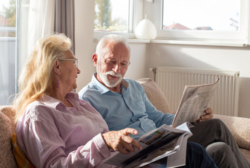Senior couple reading at home