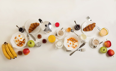 Naklejka na ściany i meble Breakfast time. Croissants and orange juice, jam and honey. Coffee with cream or milk. Fruits - bananas, red and green apples. Ricotta with sour cream, nuts and dried apricots. 