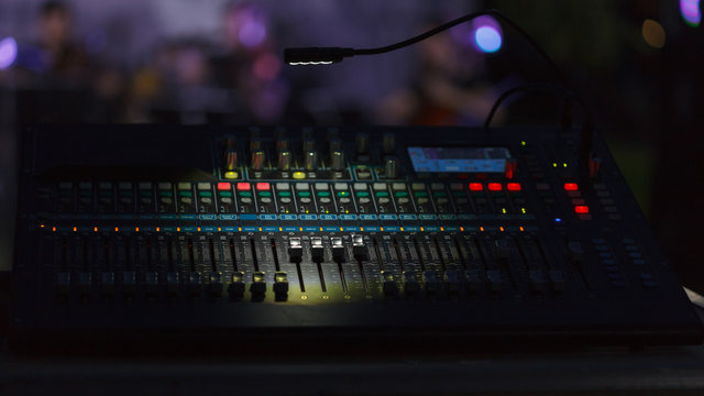Front view to the working mixing console, an electronic device for changing the volume level, timbre (tone color) of many different audio signals
