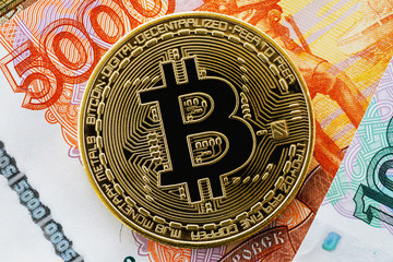 Fototapeta na wymiar Bitcoin and rubles close-up, top view